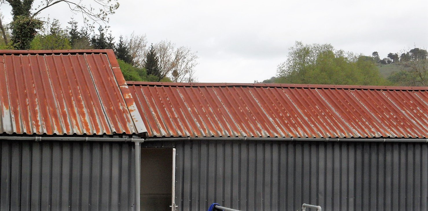 rusty metal roof that needs repairing with a liquid rubber coating to waterproof